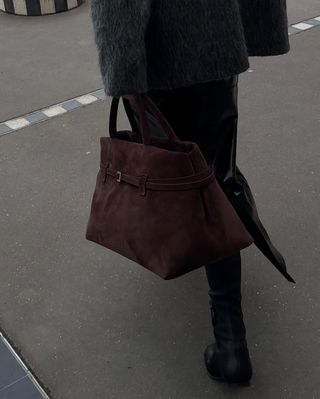 woman holding belted bag