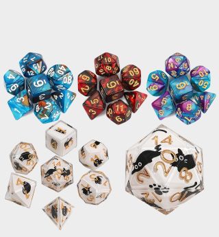 Multicolored dice and dice with cats on against a plain background