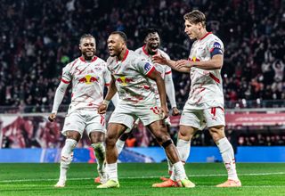 Lois Openda of RB Leipzig celebrates with teammates after scoring his team's second goal during the Bundesliga match between RB Leipzig and Borussia Dortmund at Red Bull Arena on March 15, 2025 in Leipzig, Germany.