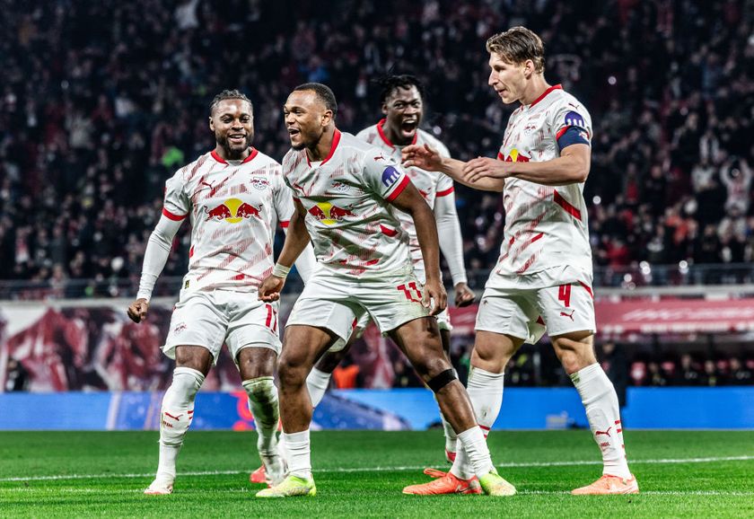 Lois Openda of RB Leipzig celebrates with teammates after scoring his team&#039;s second goal during the Bundesliga match between RB Leipzig and Borussia Dortmund at Red Bull Arena on March 15, 2025 in Leipzig, Germany.