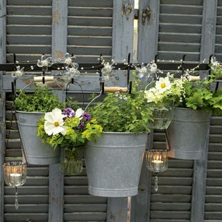 buckets and glass pot with flowers