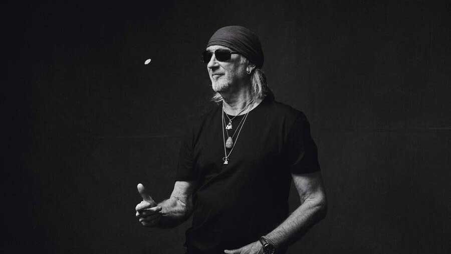 Roger Glover flipping a coin