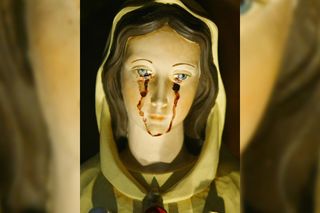 A statue of the Virgin Mary weeps a red liquid that Venezuelans said was blood on March 25, 2003 in Caracas, Venezuela.