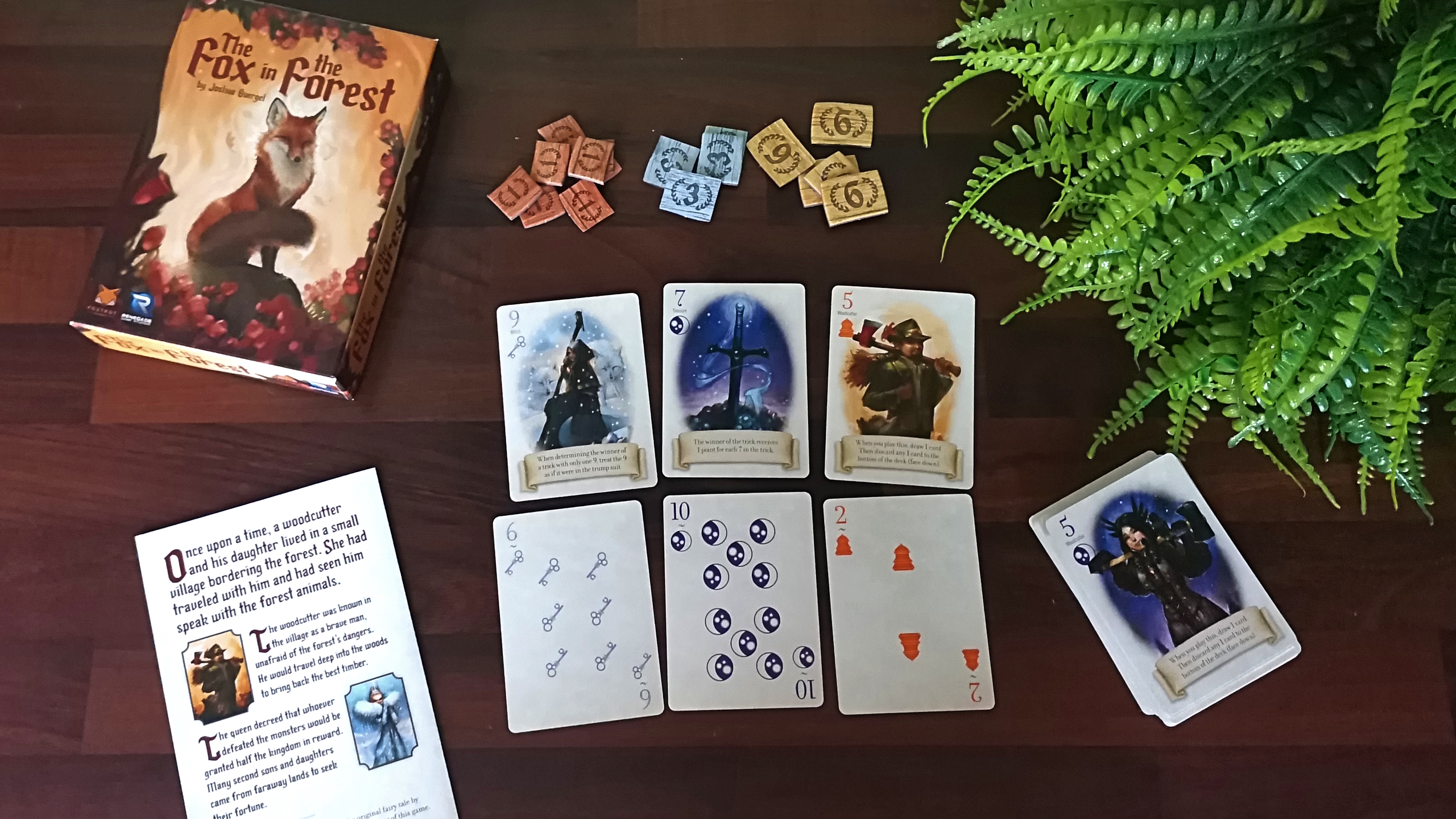 Fox in the Forest box, cards, and tokens on a wooden table