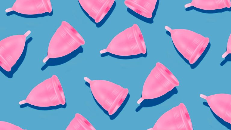Eco-friendly and reusable pink menstrual cups pattern on blue background 