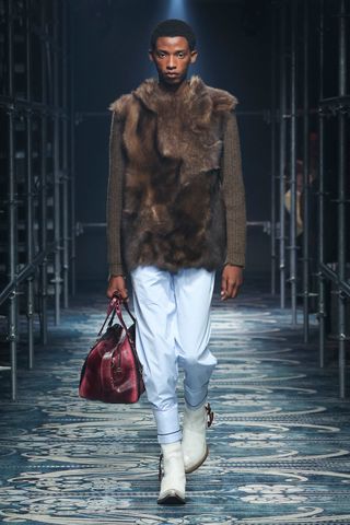 Prada A/W 2025 menswear collection featuring a model in faux fur and cowboy boots