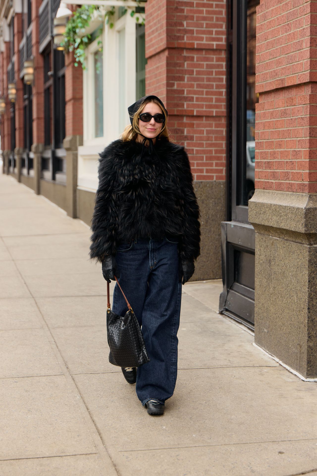 Maddie Schulz wearing a black cropped fur coat and jeans during F/W 25 fashion week in New York.