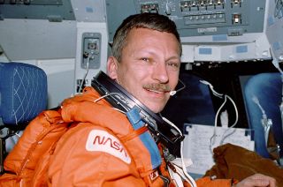 NASA astronaut Steven Nagel is seen in the commander's seat aboard the space shuttle Atlantis during the STS-55 mission in April 1991. Nagel died at age 67 on Aug. 21, 2014. 