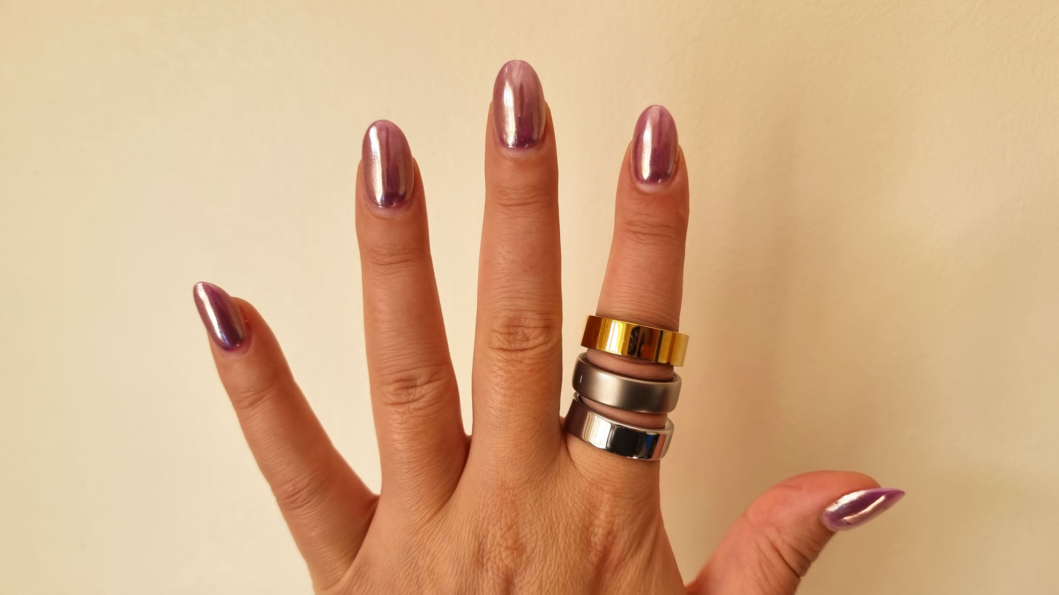 A close-up picture of our reviewer's hand wearing three smart rings 