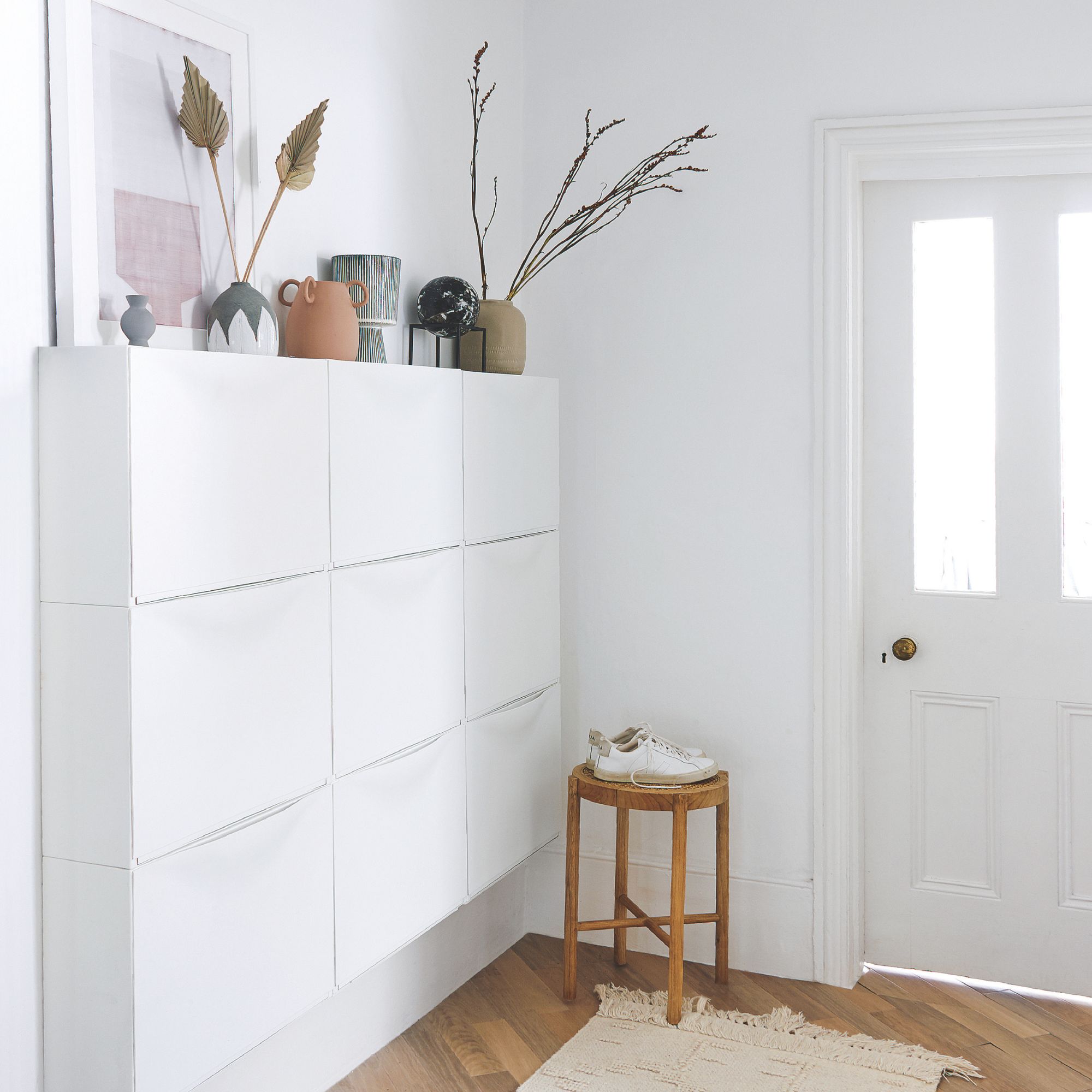 White hallway with wall-mounted shoe storage units