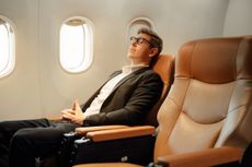 Businessman sleep while sitting in airplane