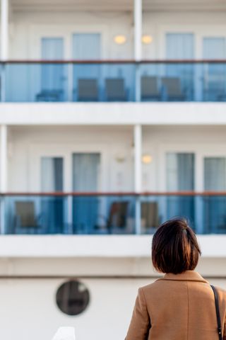 woman looking at a cruise ship