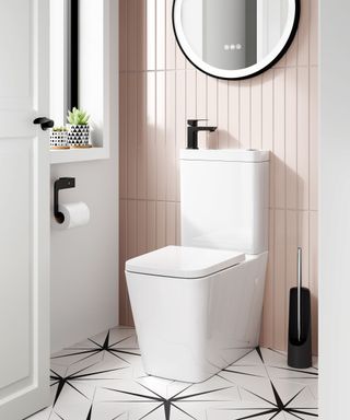 Modern small bathroom featuring soft blush vertical tiles, a sleek integrated toilet with a compact sink, and black matte accents.