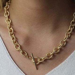 close up image of neck with gold necklace