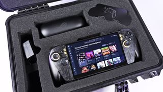 Open Pelican case with custom foam holding the powered-on ROG Ally X20 handheld, 68W charger, and AR glasses case.
