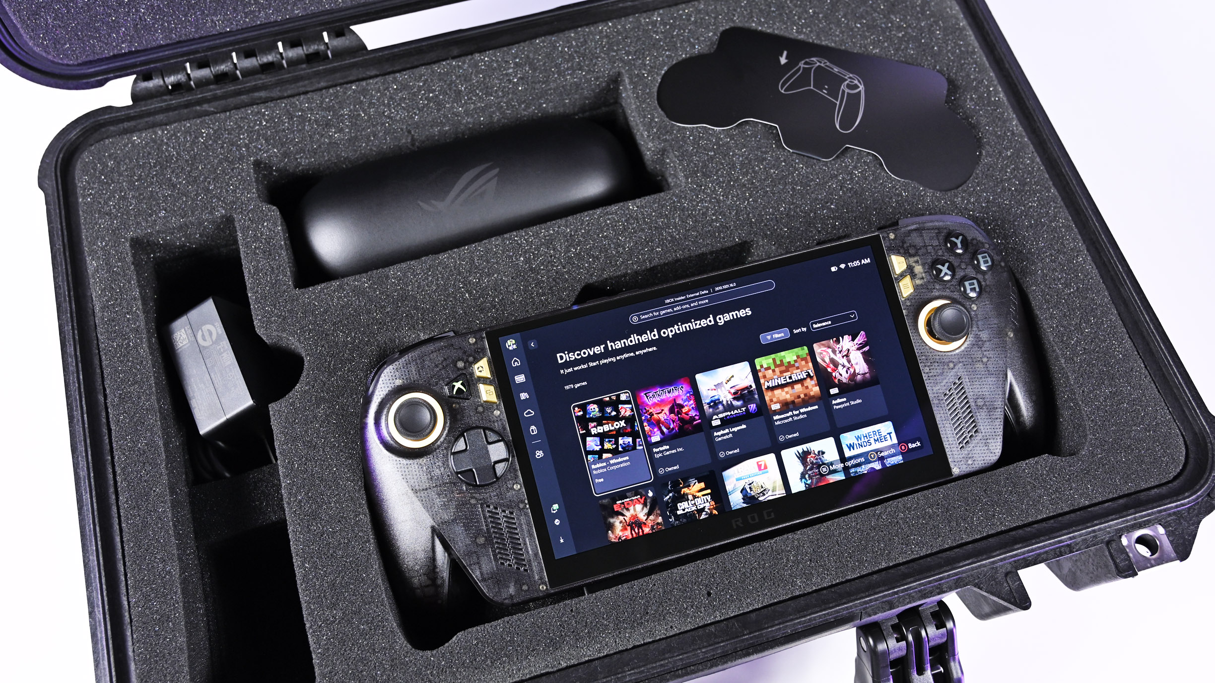 Open Pelican case with custom foam holding the powered-on ROG Ally X20 handheld, 68W charger, and AR glasses case.