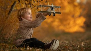 Portrait of child with toy plane