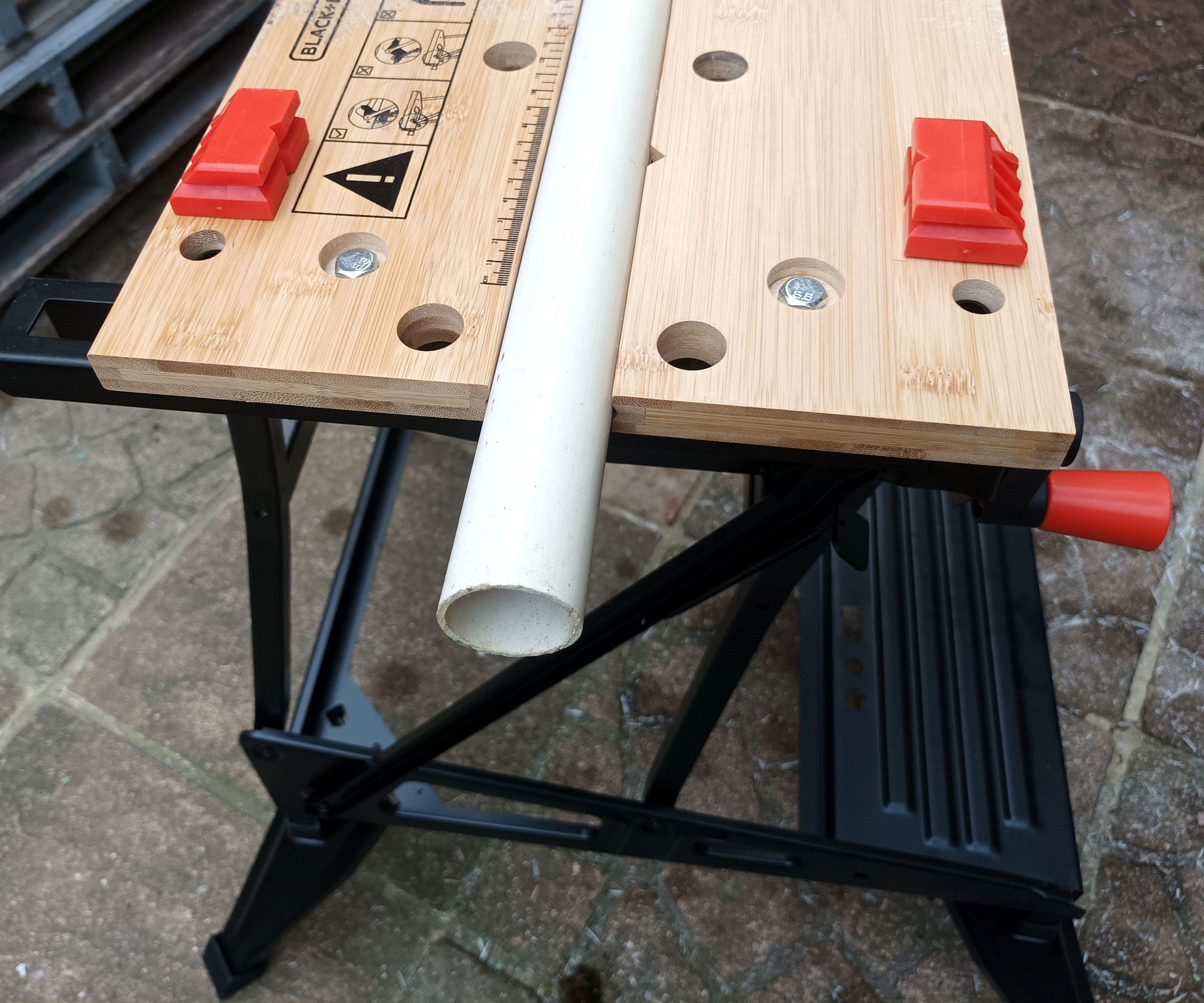 Black &amp;amp; Decker Workmate WM536 holding white 40mm plastic pipe