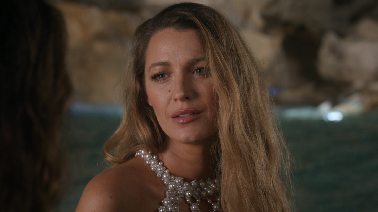 Blake Lively sits looking upset in front of a fountain at night in Another Simple Favor.