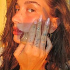 An image of Hailey Bieber with glazed nails.