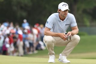 Thomas Detry lines up a putt with a putter in hand