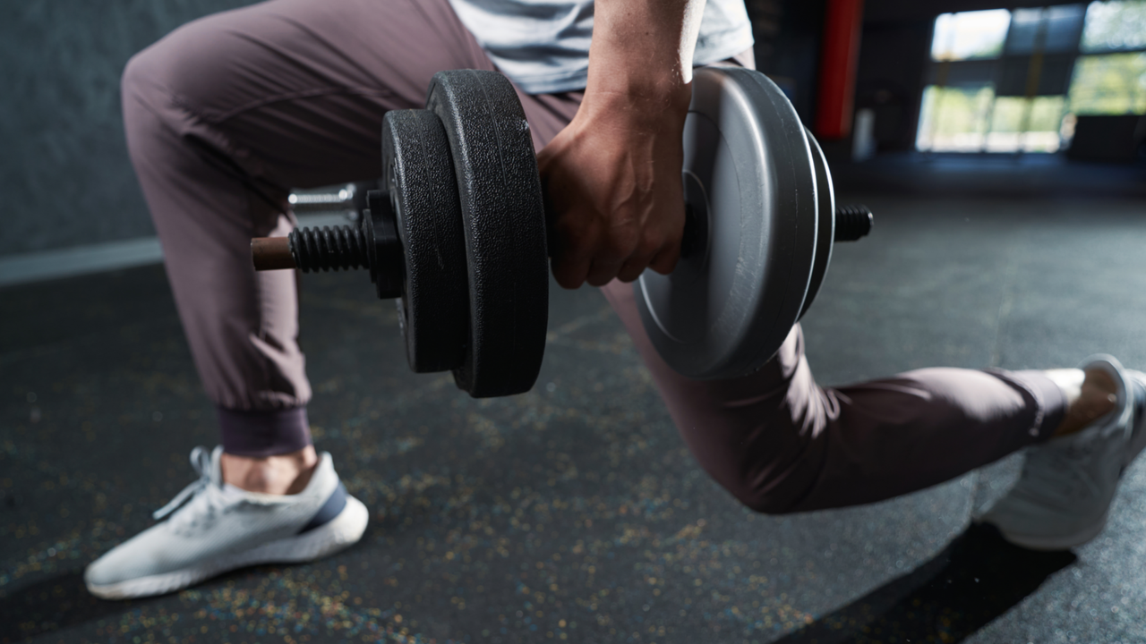 Man lunging with dumbbell