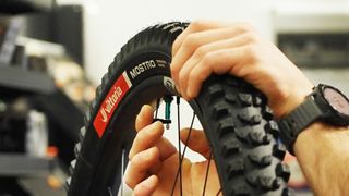 The Vittoria Mostro tire being fitted on wheel