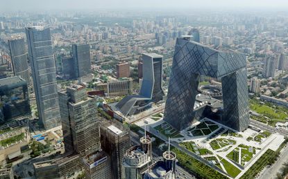 BEIJING, CHINA - AUGUST 03:A general view shows the headquarter of China Central Television amid the Beijing skyline at central business district on August 3, 2013 in Beijing, China.(Photo by