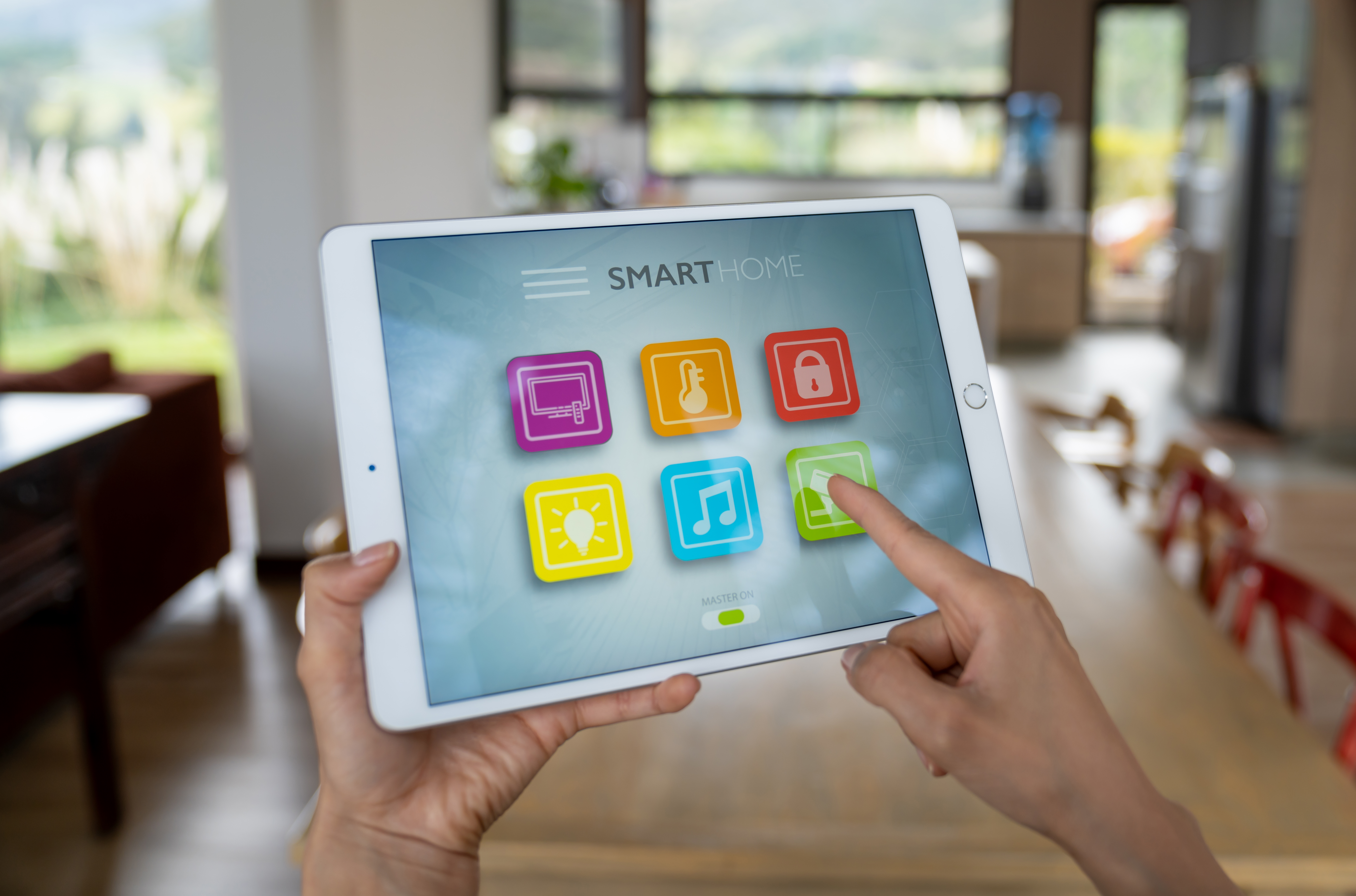Inside a kitchen area with a close up image of an ipad screen showing smart home apps