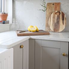 Grey Shaker kitchen with brass cabinet knobs