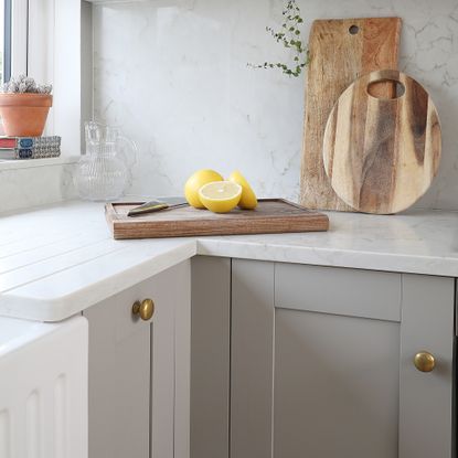 Grey Shaker kitchen with brass cabinet knobs
