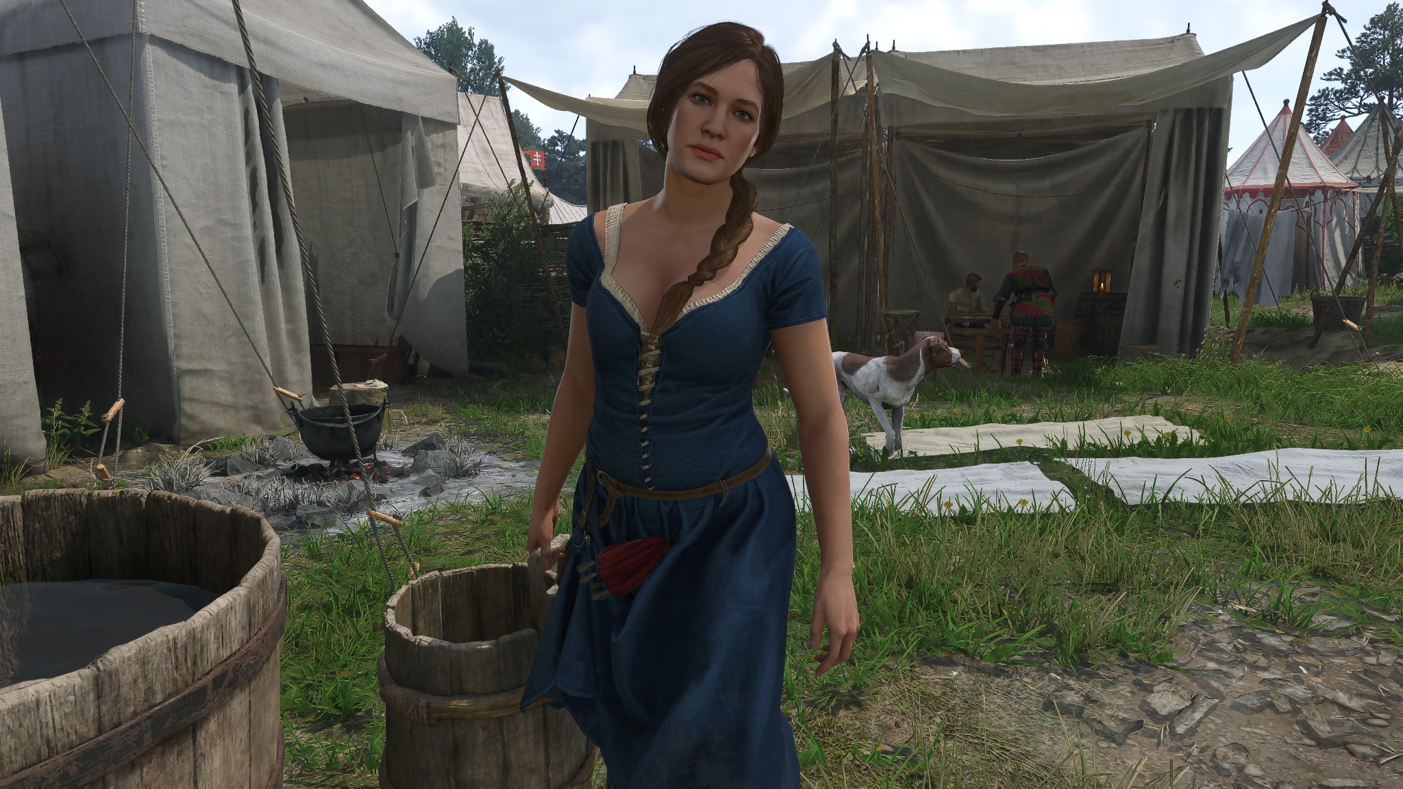 Katherine carries a bucket of water around camp.