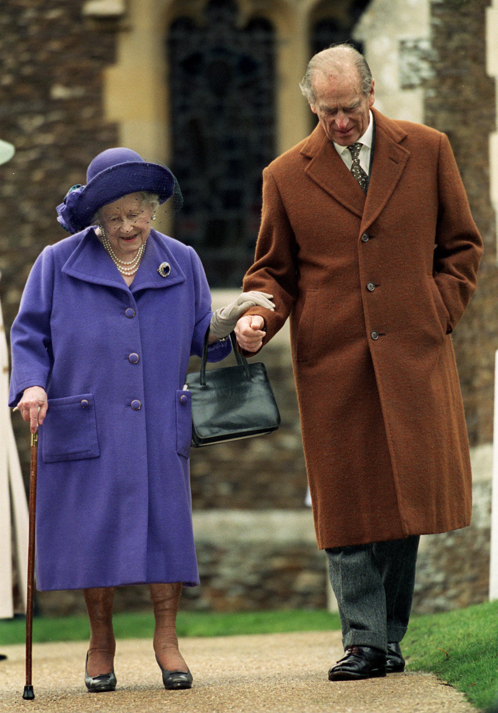 Prince Philip holding the Queen Mother's arm outside church on Christmas Day 1999