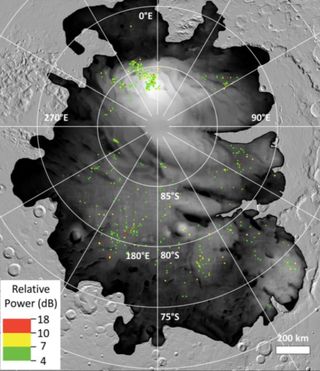 The colored dots represent sites where bright radar reflections have been spotted by ESA’s Mars Express orbiter at Mars’ south polar cap. Such reflections have previously been interpreted as subsurface liquid water, but their prevalence and proximity to the surface suggests they may be something else.