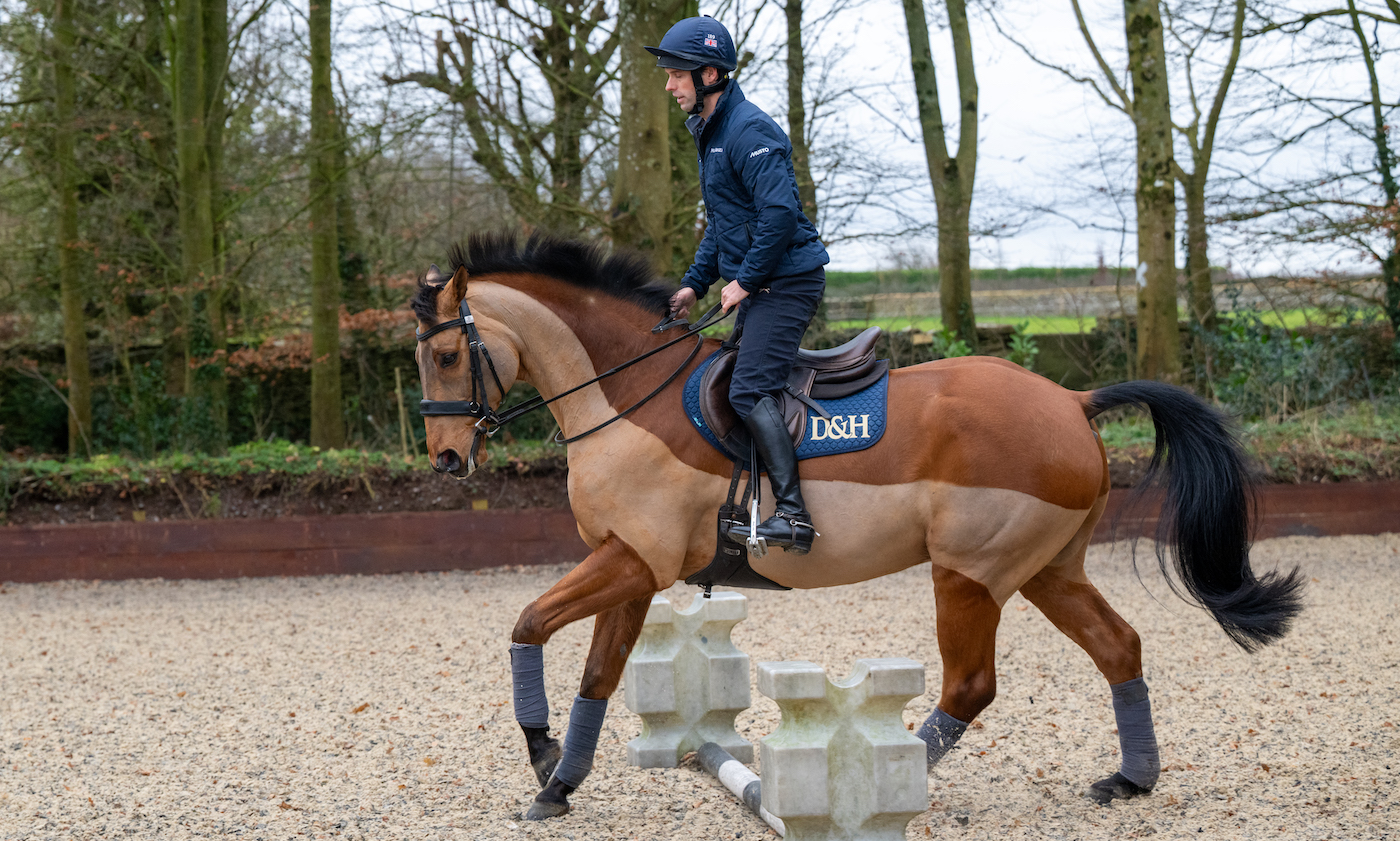 A rider in a two-point position for a polework exercise