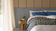 A contemporary bedroom with tiled and wood-paneled walls