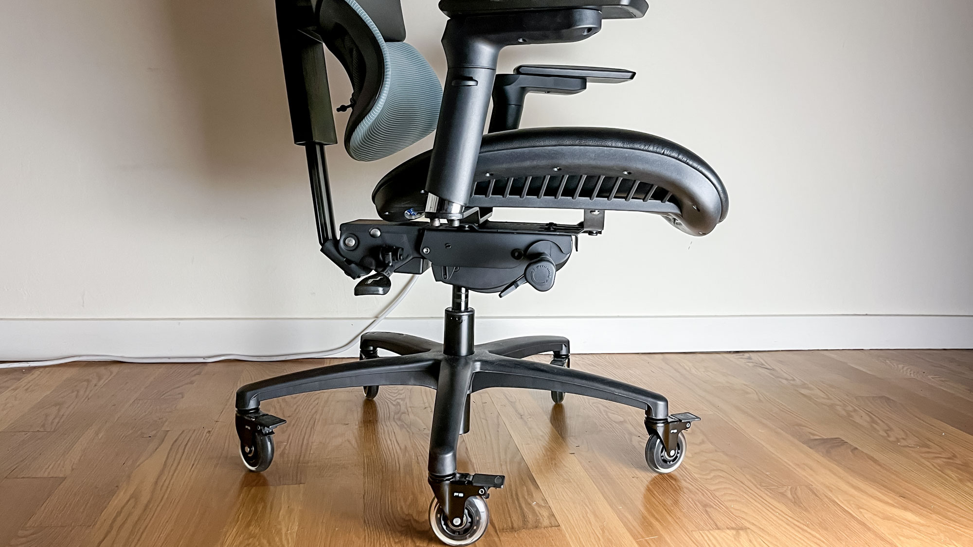 Mavix M9 gaming chair in front of my desk, with lower half and adjustment levers in frame