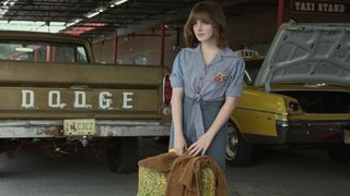 Mckenna Grace as Jan Broberg carrying a suitcase in A Friend of the Family