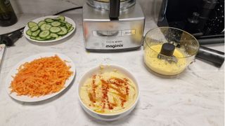 Magimix 4200XL Food Processor with a bowl of hummus in front