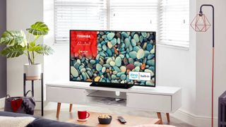 Toshiba UK31 TV on display in a living room surrounded by modern furniture