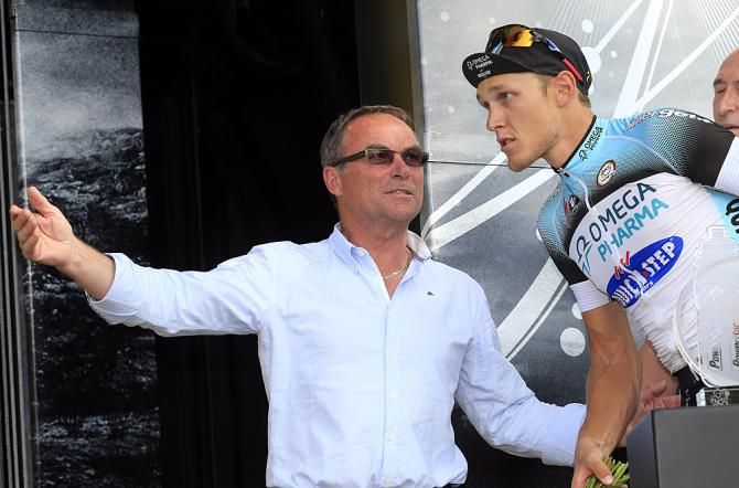 Bernard Hinault escorts Matteo Trentin onto the winner's podium