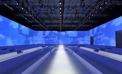 Milan's Palazzo Mezzanotte were emblazoned with moving images of a deep blue sky, superimposed with geometric elements that echoed the forms of the modular white seating.