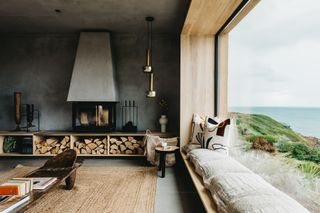 a concrete look room with a fireplace and picture window