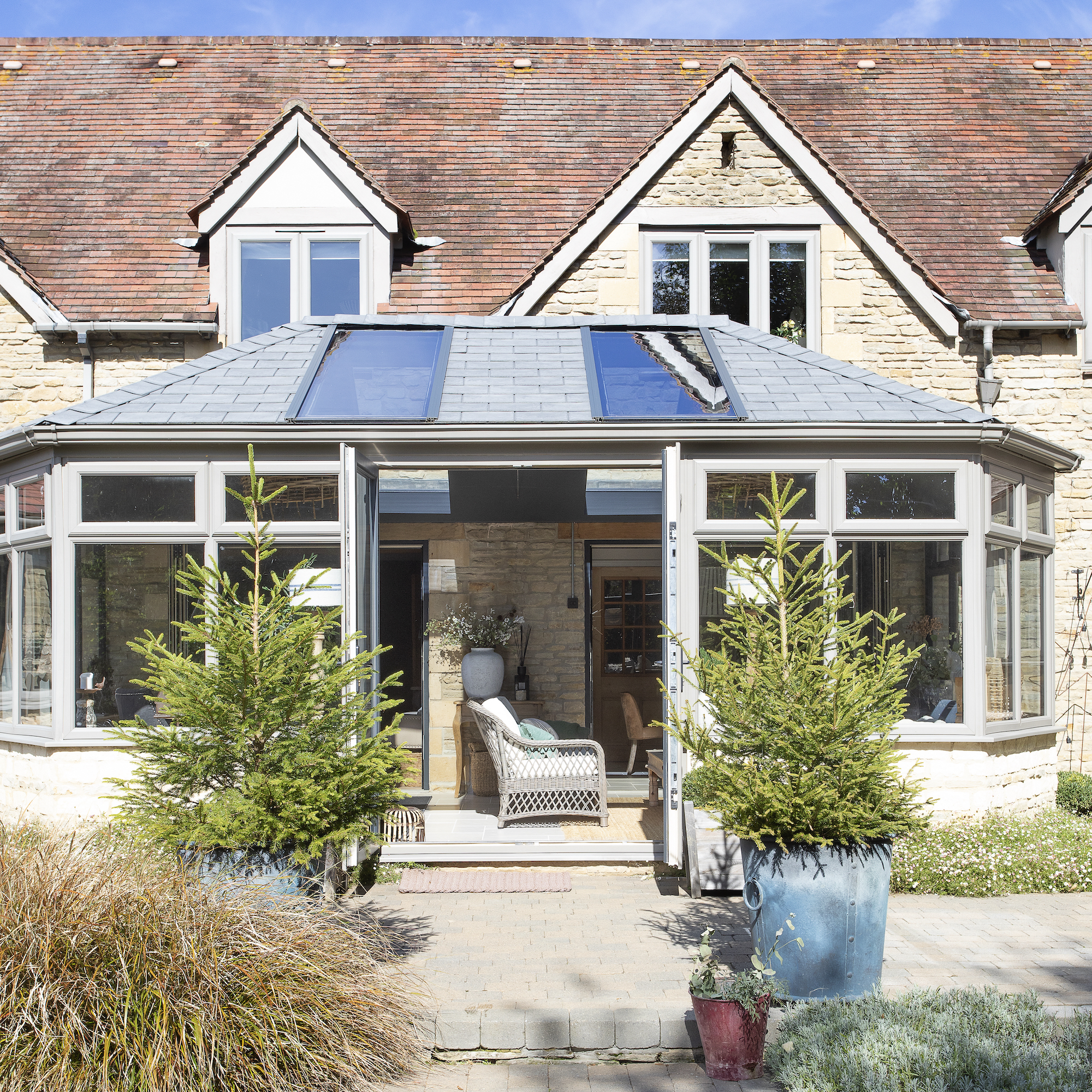 exterior of house showing garden room with roof lights and patio doors