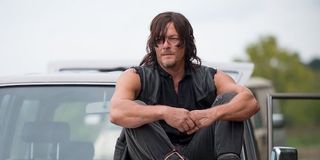 Daryl sitting on a car