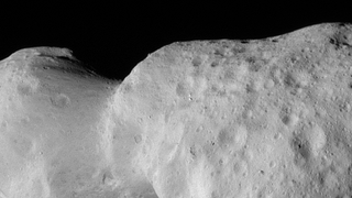 A black and white image of a space rock with a black background.