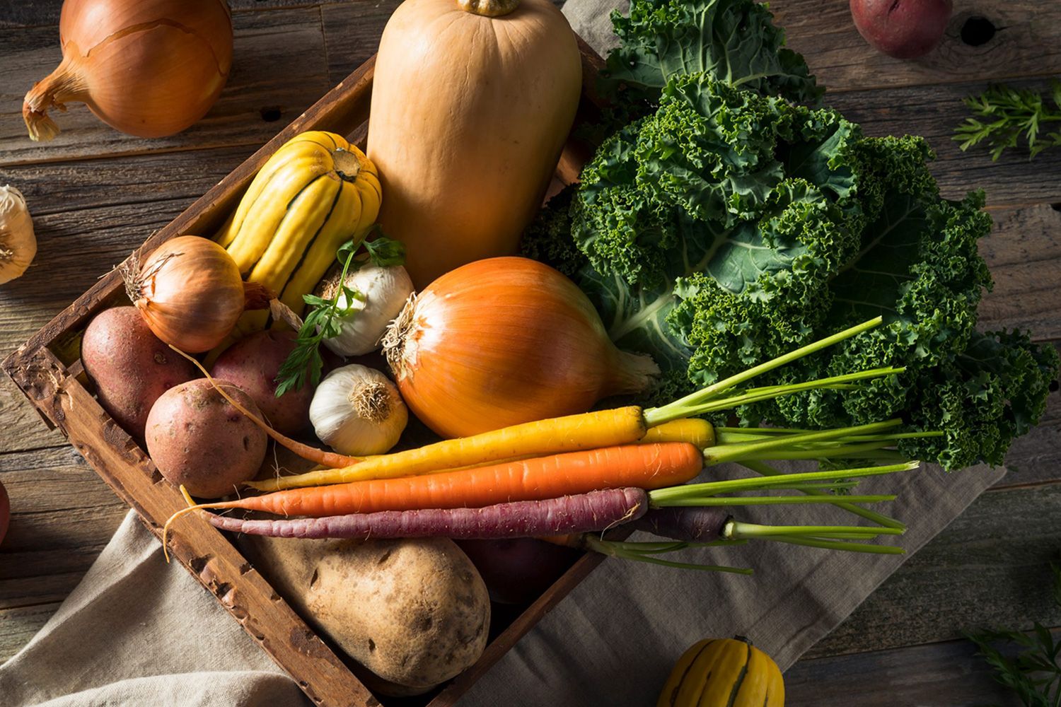 A bowl of vegetables including carrots and onions