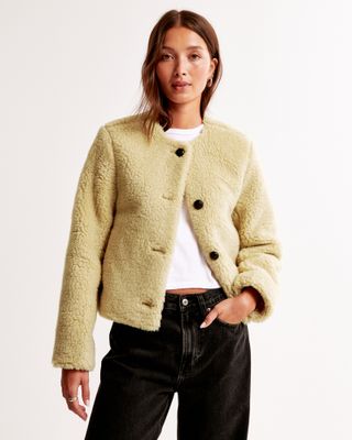 Collarless shearling coat