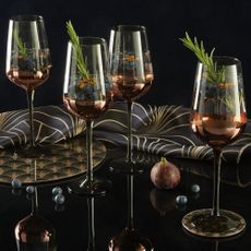glassware with black cocktail and wine glass