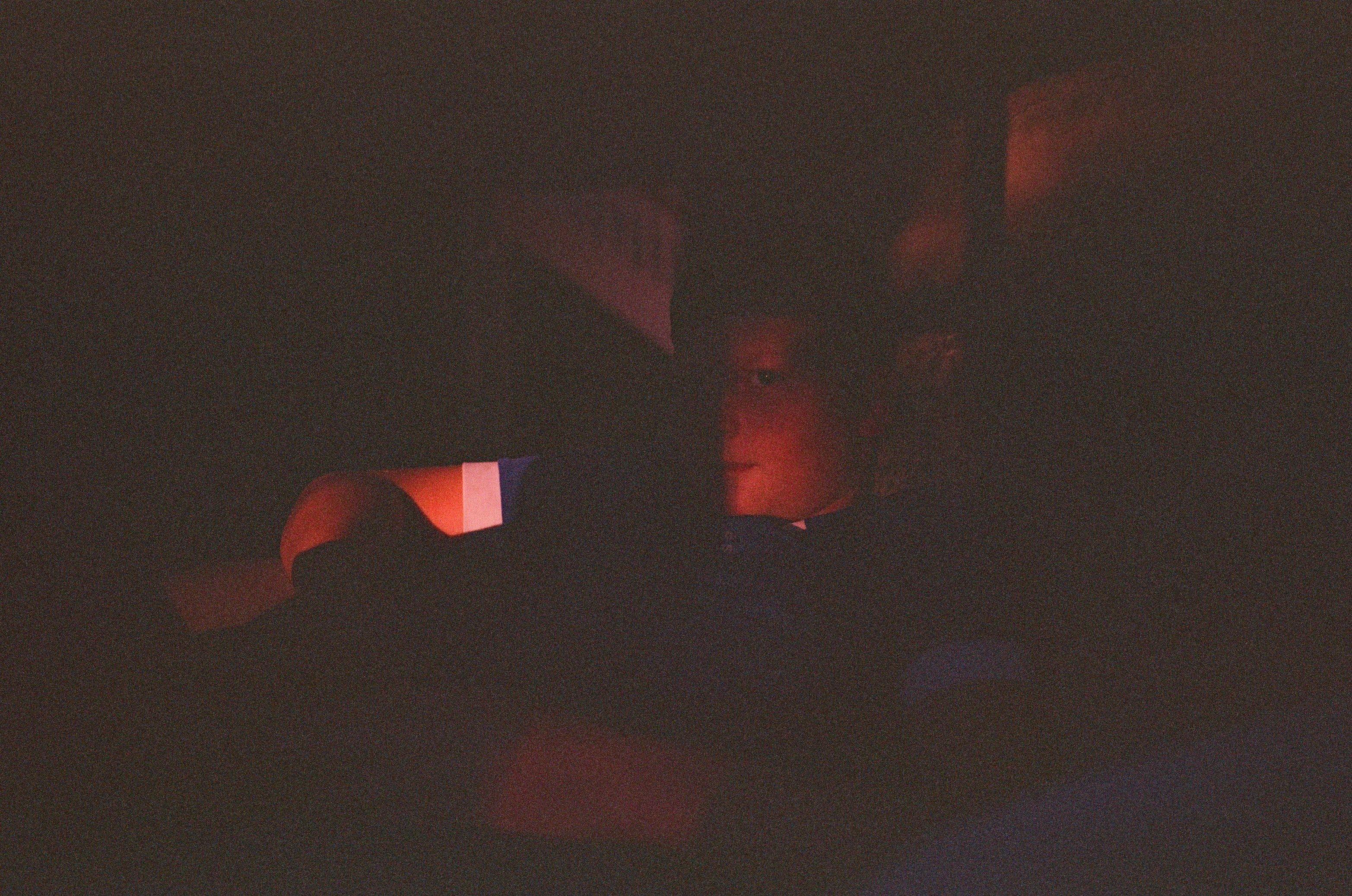 Leica MP color film scan of adolescent boy illuminated a little by last light coming through a window